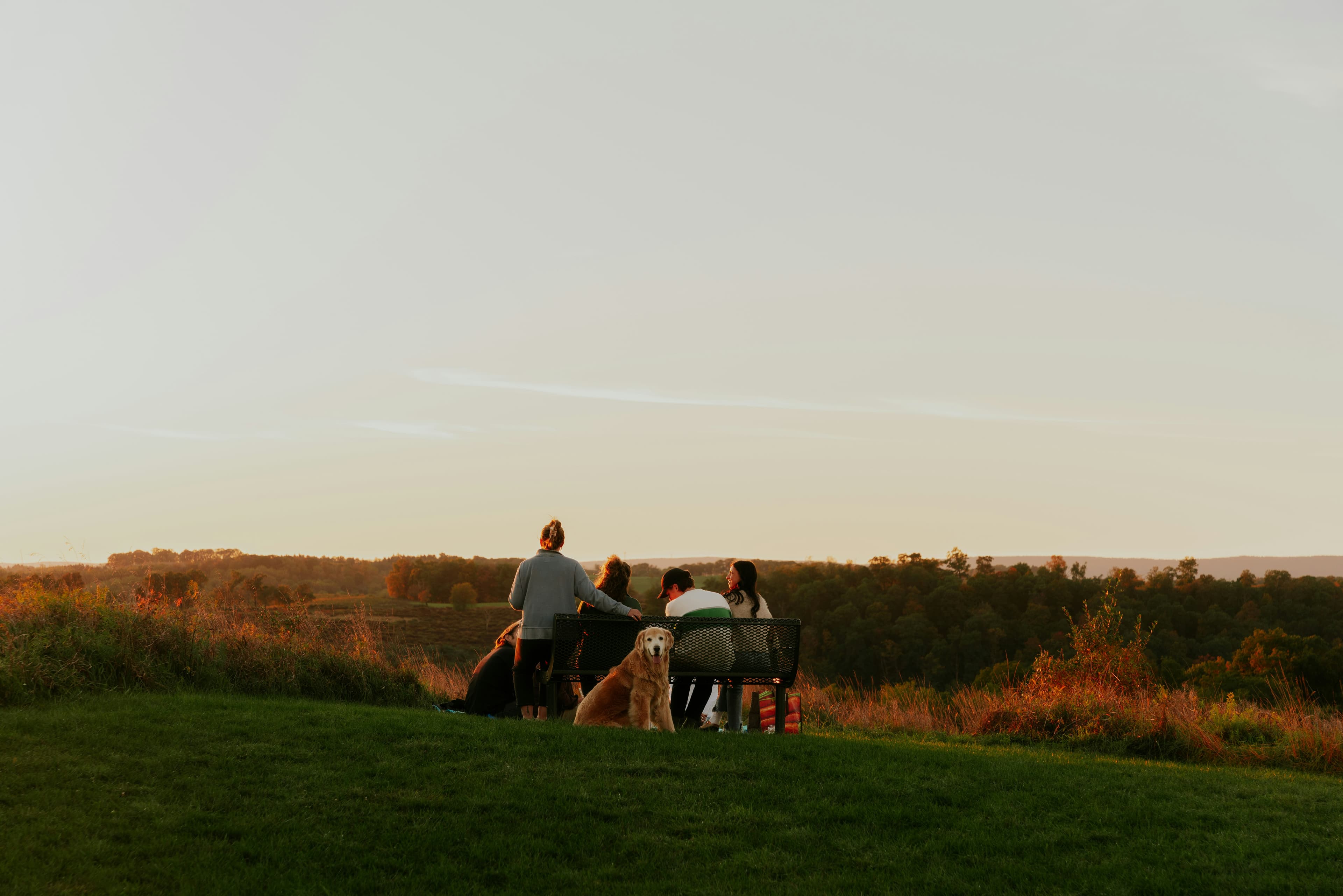 Christian family together on a lush green field